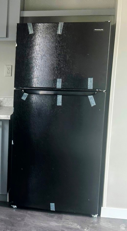 Details featuring freestanding refrigerator and light countertops