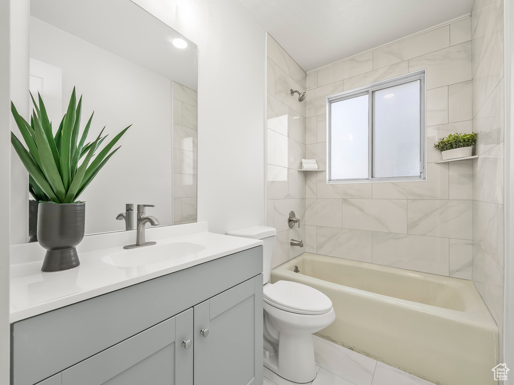 Full bath with vanity, bathtub / shower combination, and toilet