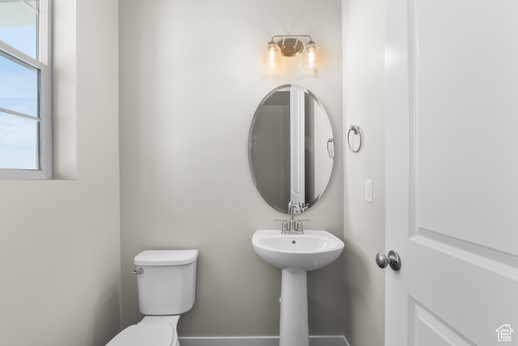 Bathroom with a healthy amount of sunlight and toilet