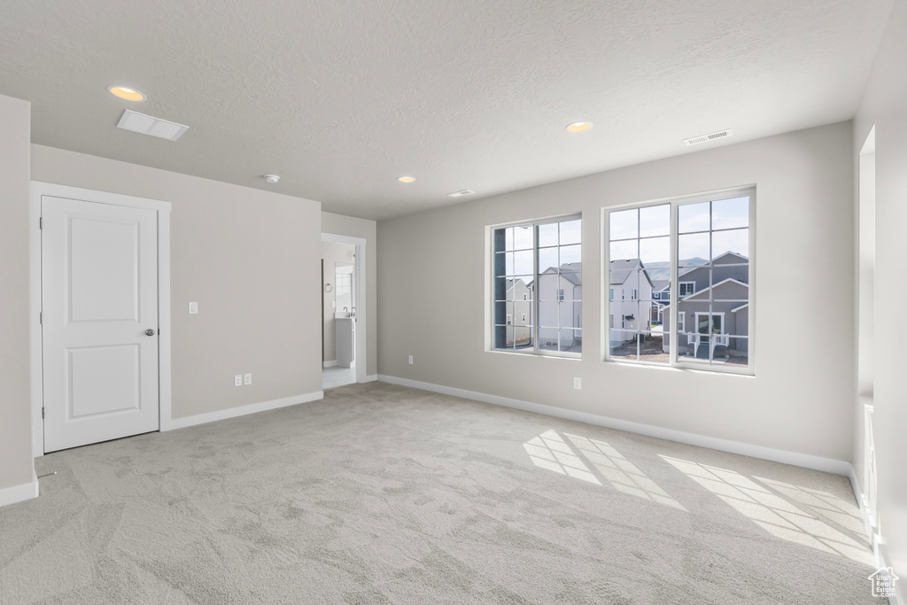 Spare room featuring visible vents, recessed lighting, baseboards, and light colored carpet