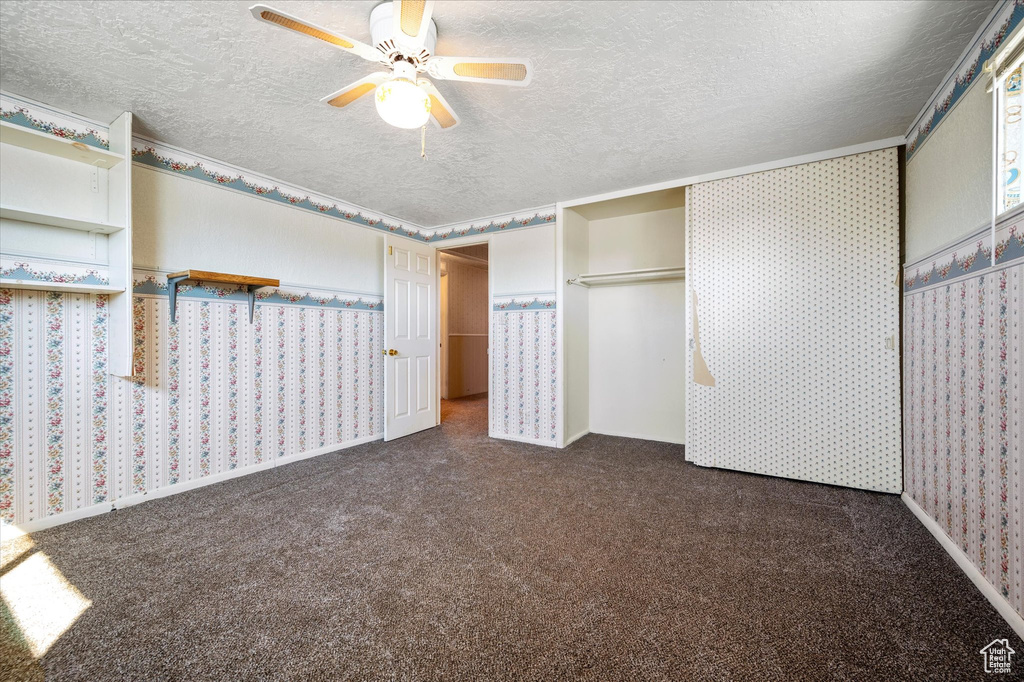 Unfurnished bedroom with carpet floors and a textured ceiling