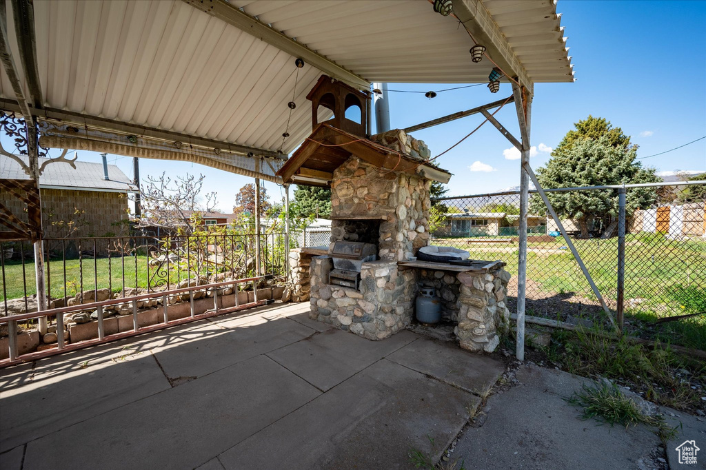 View of patio featuring grilling area and fence