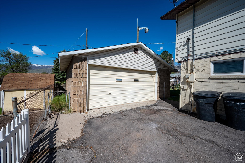 Detached garage featuring fence