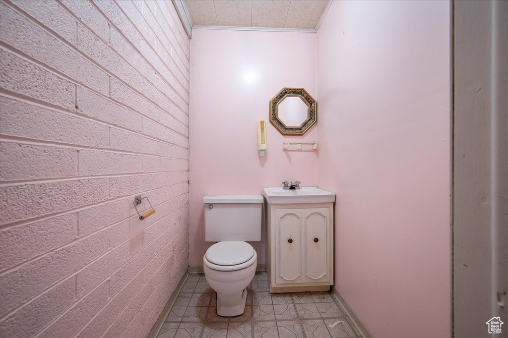 Bathroom featuring tile patterned floors, vanity, and toilet