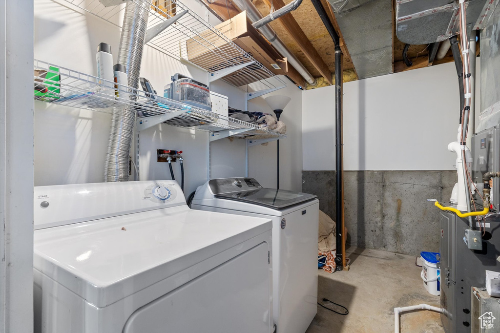 Washroom featuring laundry area and washer and clothes dryer