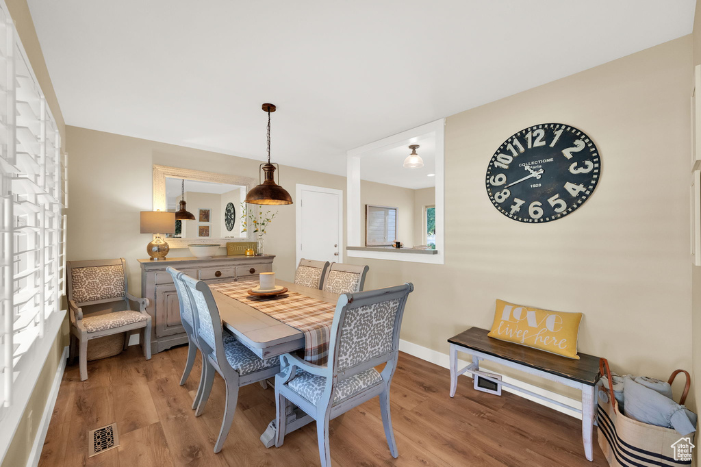 Dining room featuring visible vents, baseboards, and light wood-type flooring