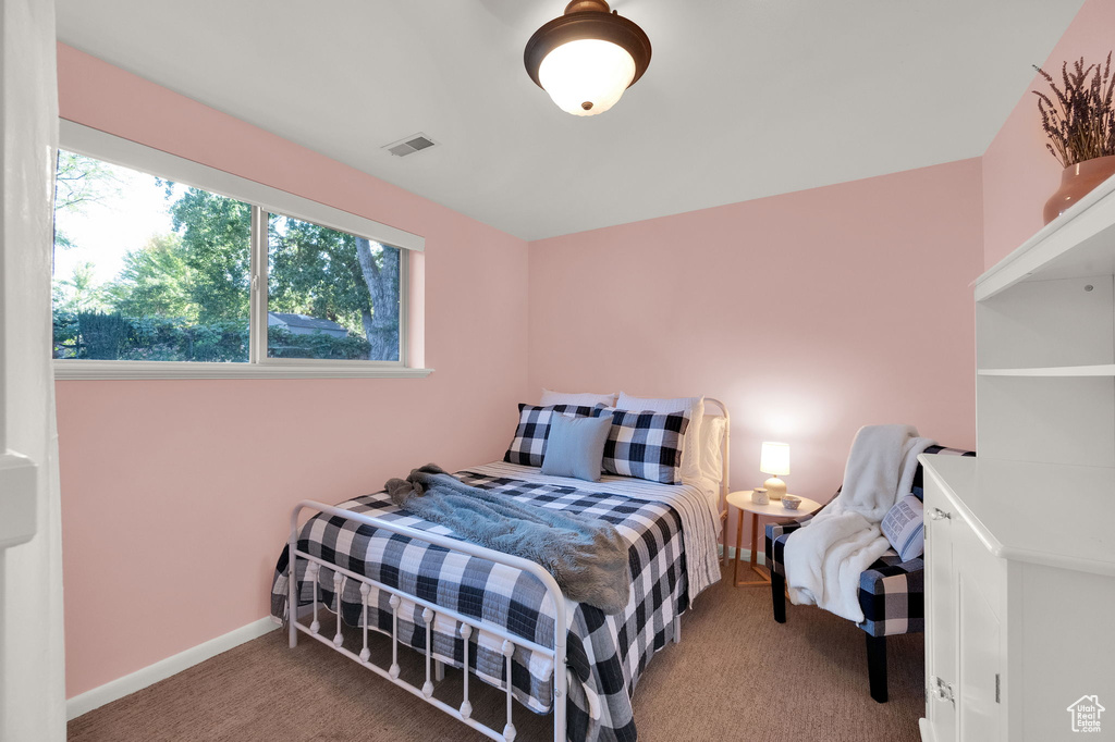 Bedroom with visible vents, carpet flooring, and baseboards