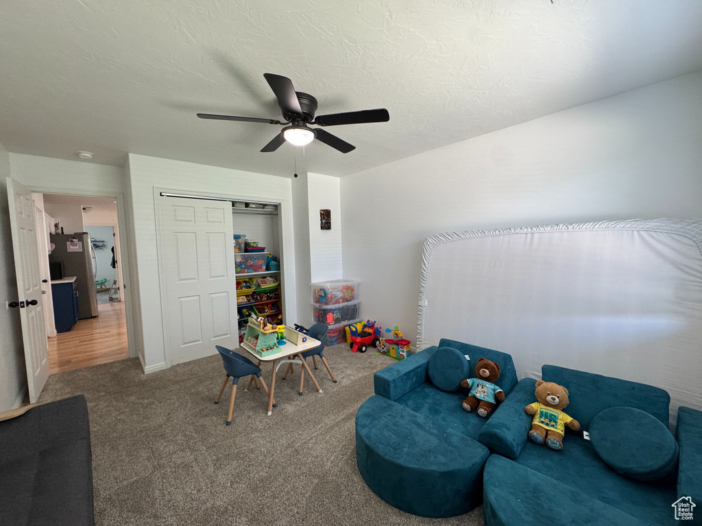 Game room featuring carpet floors and ceiling fan