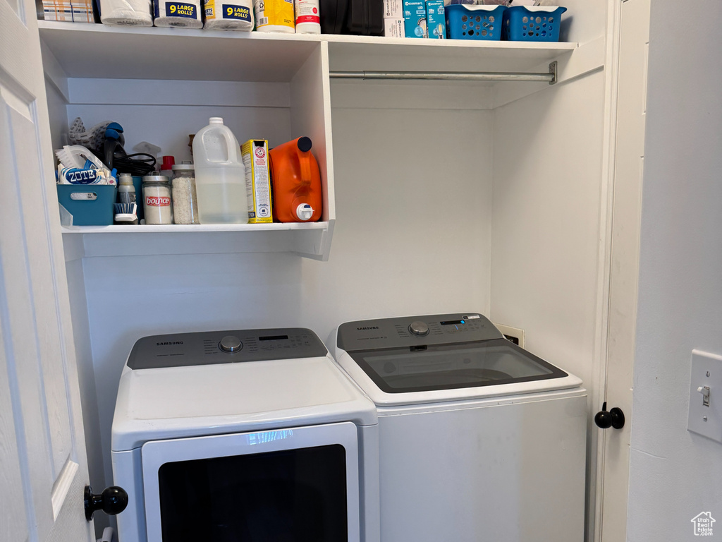 Clothes washing area featuring laundry area and washer and dryer