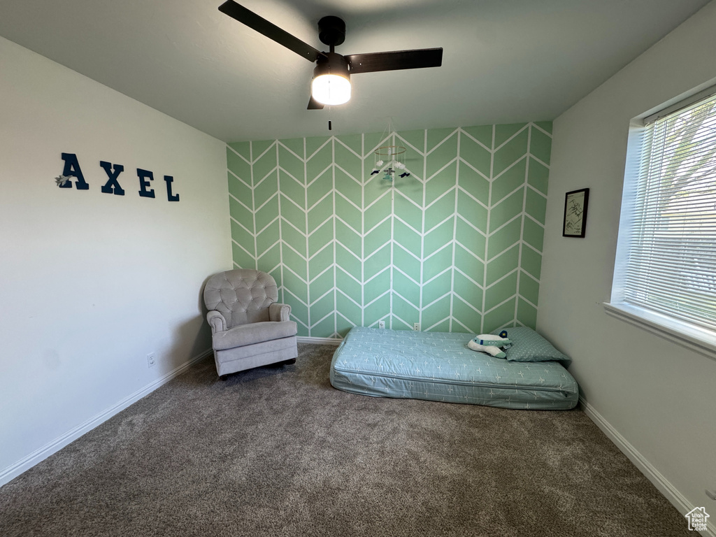 Carpeted bedroom with baseboards and ceiling fan