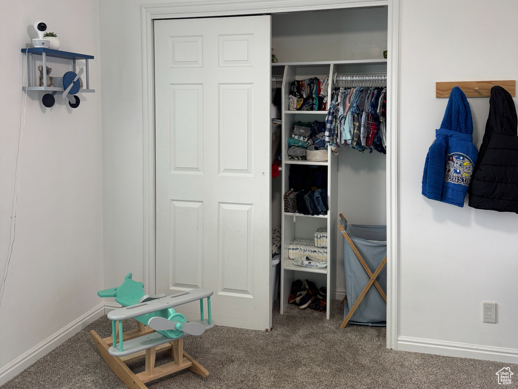Bedroom featuring a closet, carpet, and ceiling fan