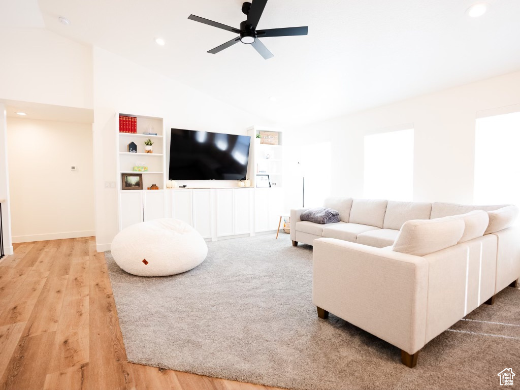 Living room featuring high vaulted ceiling, a ceiling fan, recessed lighting, and wood finished floors