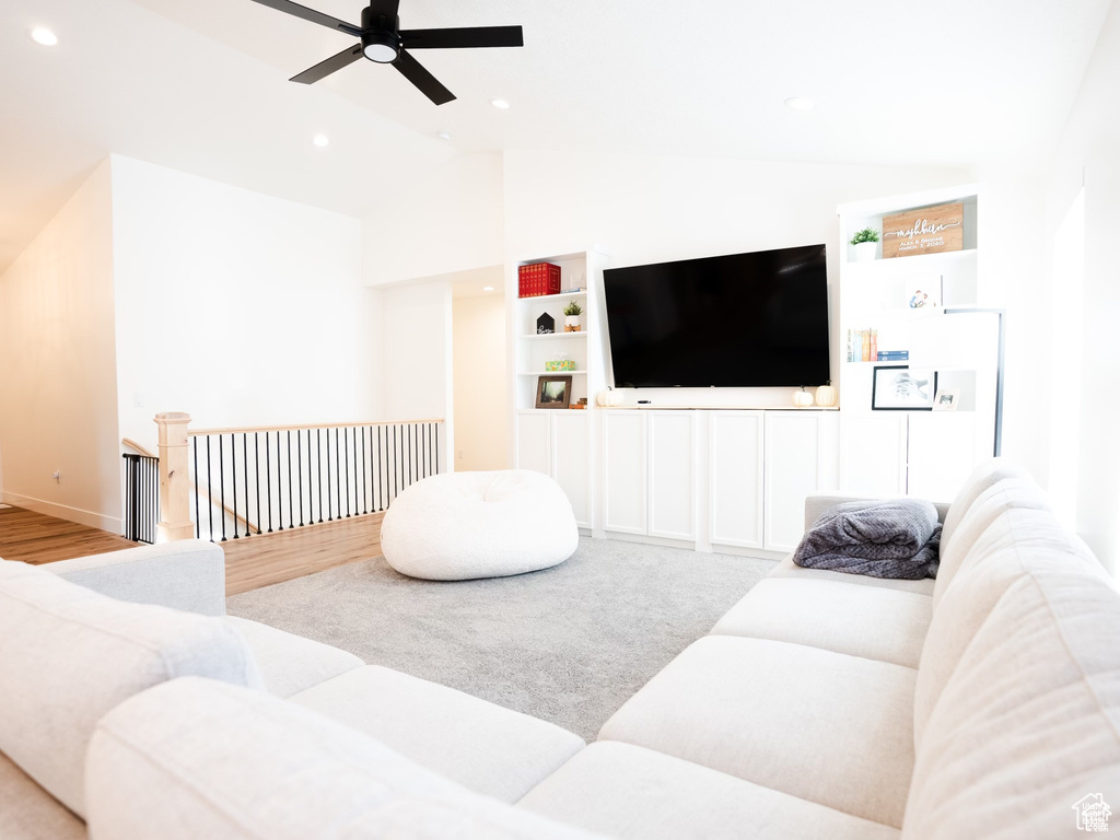 Living room featuring a ceiling fan, recessed lighting, wood finished floors, and lofted ceiling
