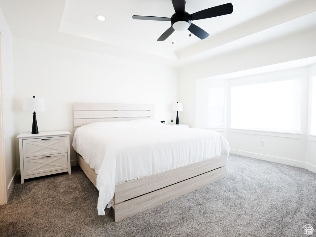 Bedroom with baseboards, ceiling fan, recessed lighting, a raised ceiling, and carpet