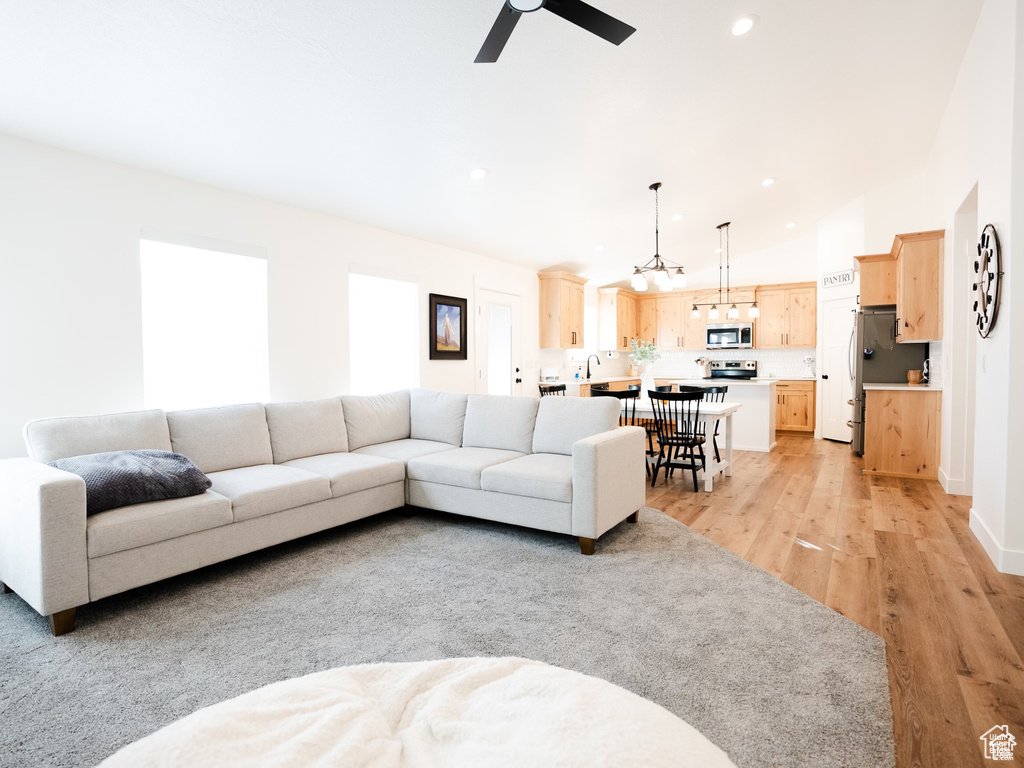 Living room featuring recessed lighting, ceiling fan, and light wood finished floors