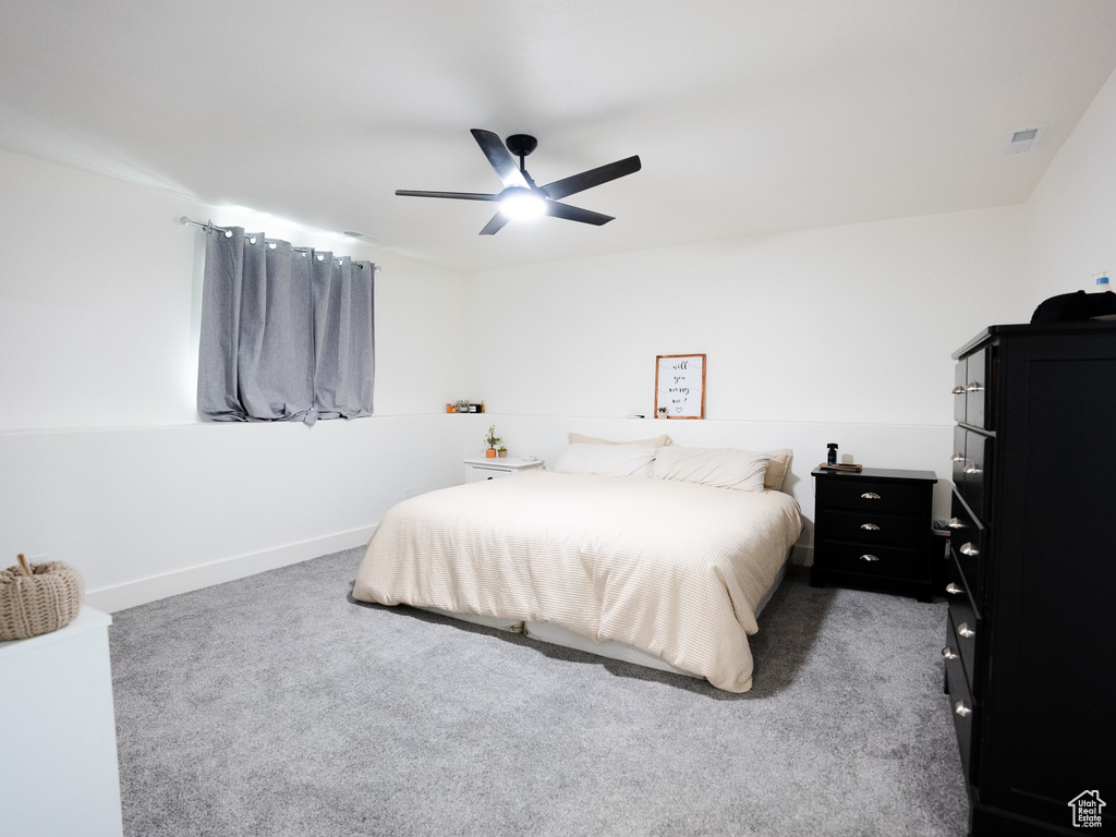 Bedroom with baseboards, a ceiling fan, carpet, and visible vents