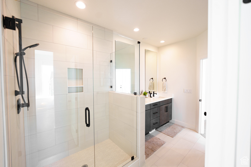 Full bath with vanity, a shower stall, recessed lighting, and tile patterned flooring