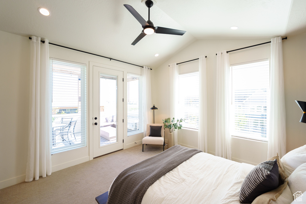 Bedroom featuring lofted ceiling, carpet flooring, access to outside, and multiple windows