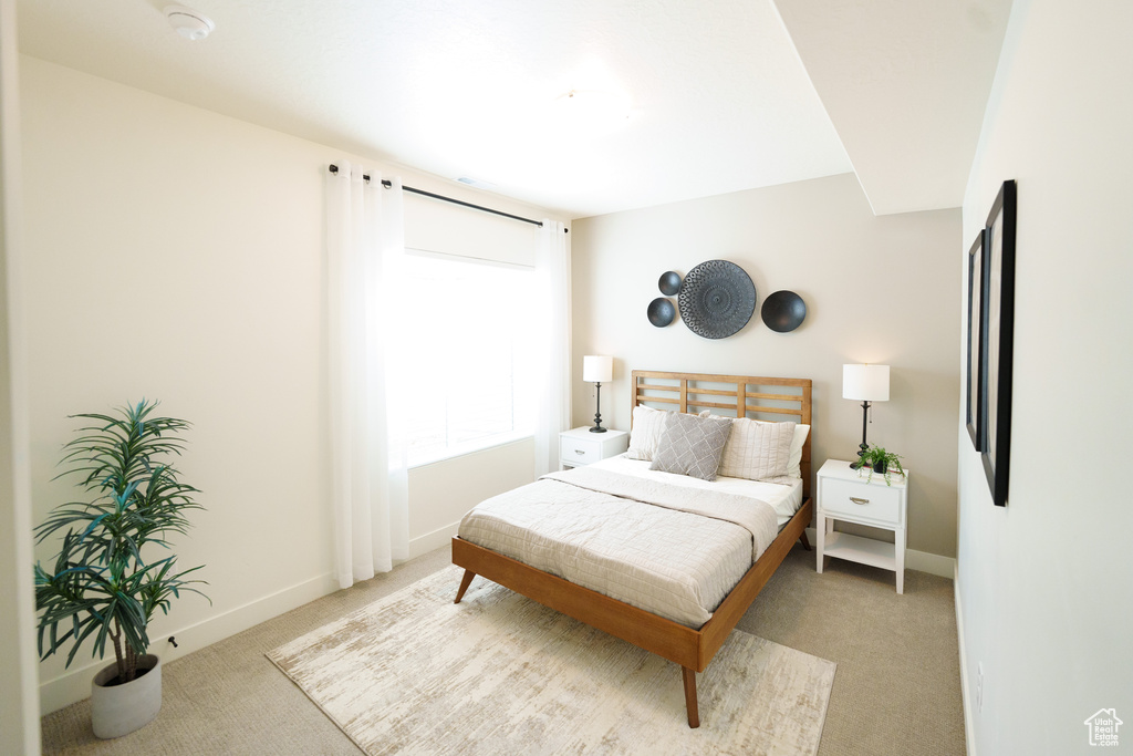 Carpeted bedroom featuring baseboards