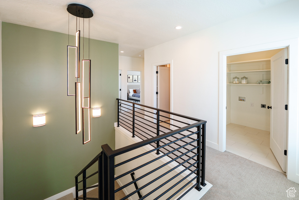 Interior space with baseboards, recessed lighting, an upstairs landing, and carpet floors