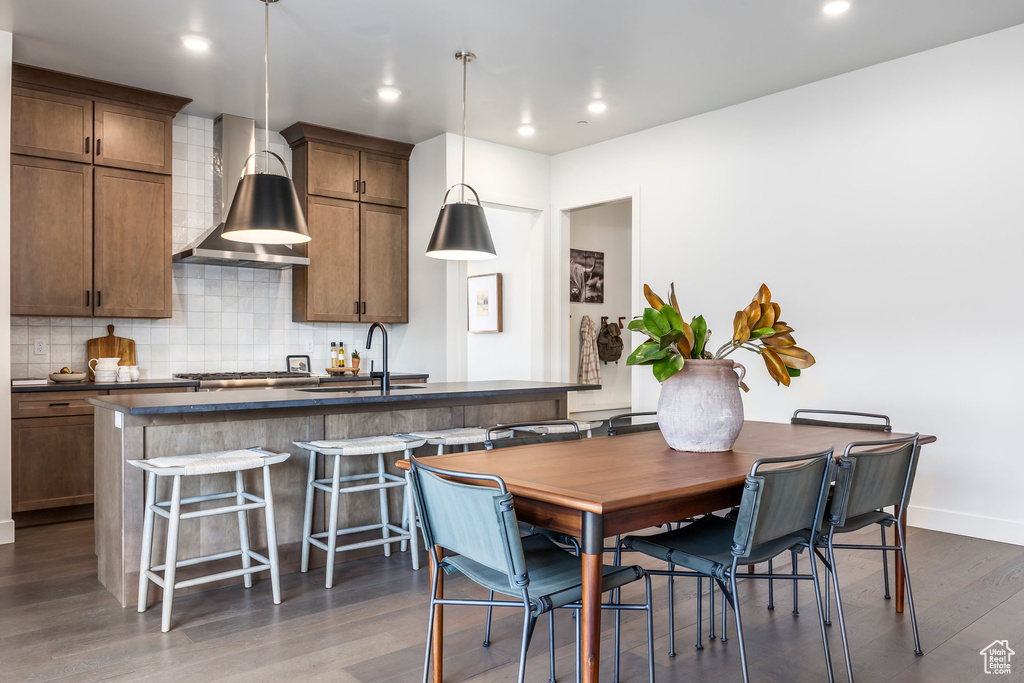 Dining space with recessed lighting, baseboards, and dark wood-style floors