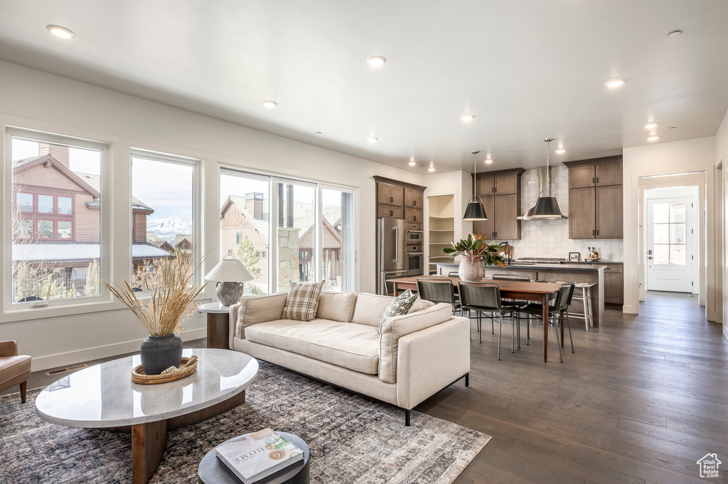 Living area featuring recessed lighting and dark wood-style floors