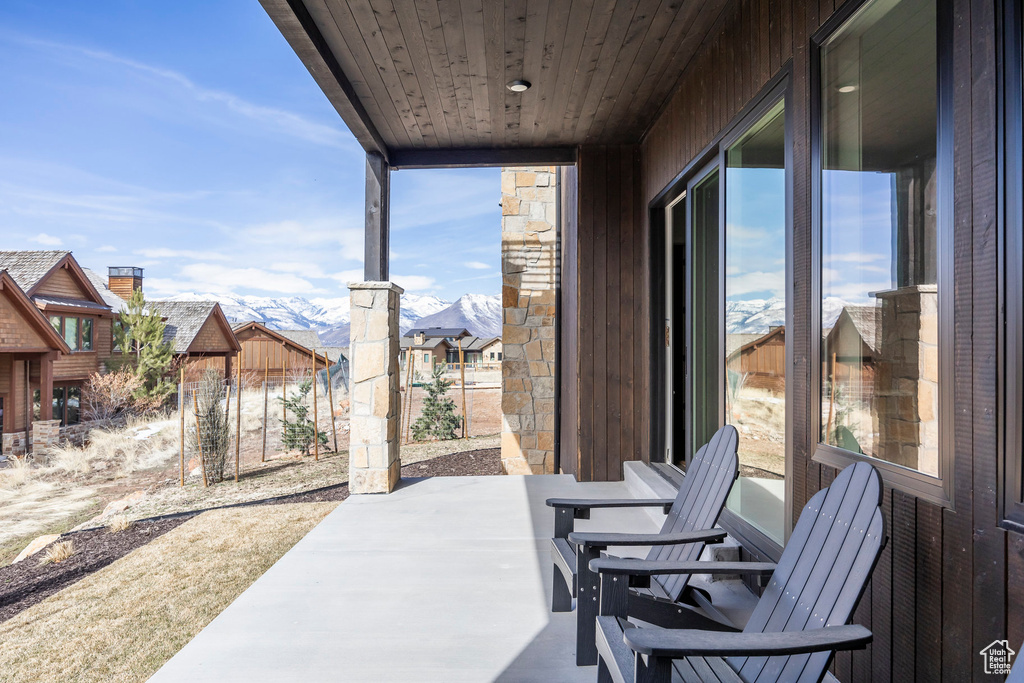 View of patio featuring fence and a mountain view