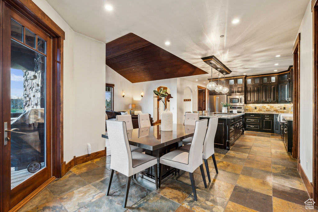 Dining area featuring baseboards, recessed lighting, and stone tile floors
