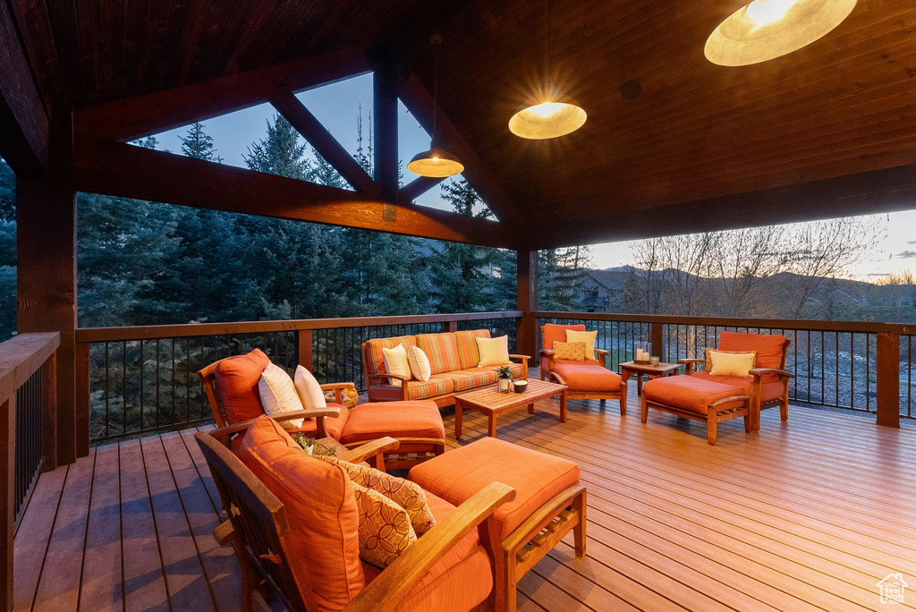 Deck featuring a mountain view and an outdoor living space