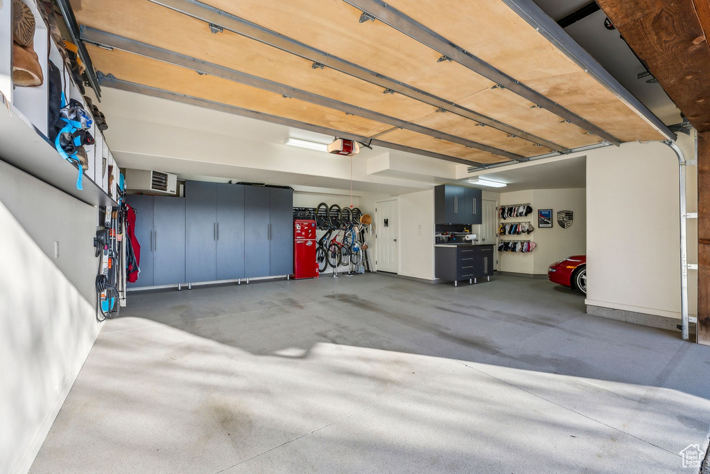 Garage with baseboards and a garage door opener