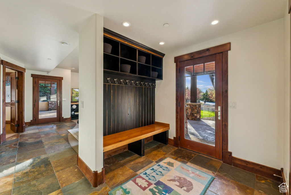 Mudroom featuring stone tile flooring, recessed lighting, and baseboards
