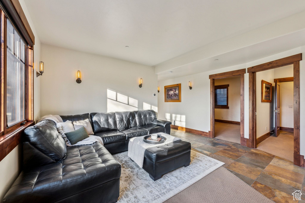 Living area with baseboards and stone tile flooring