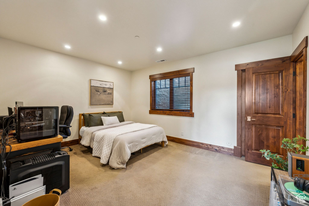 Carpeted bedroom with recessed lighting, baseboards, and visible vents