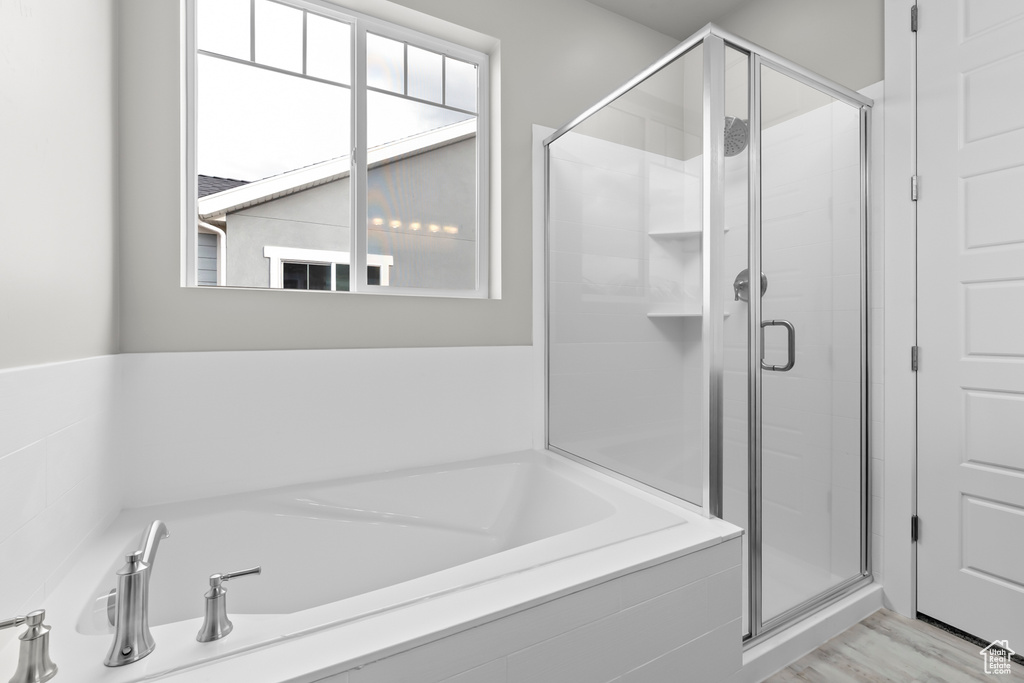 Full bathroom with a bath and a shower stall