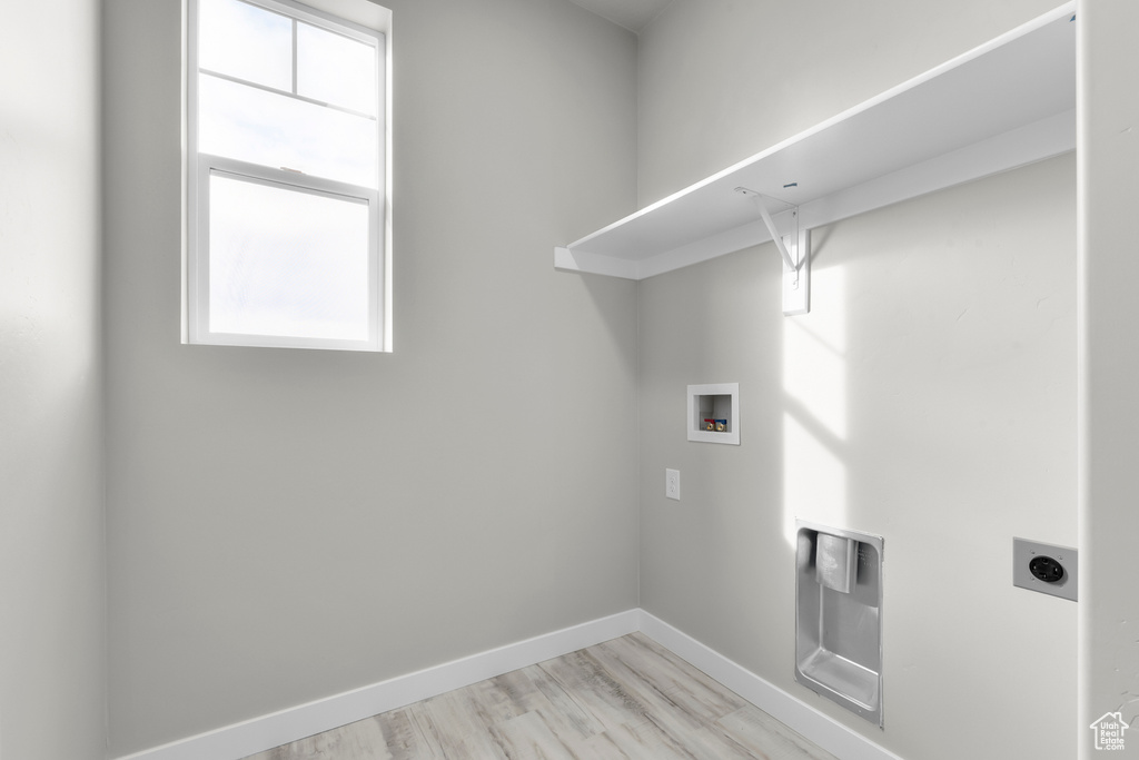 Laundry area with hookup for an electric dryer, laundry area, hookup for a washing machine, and a wealth of natural light