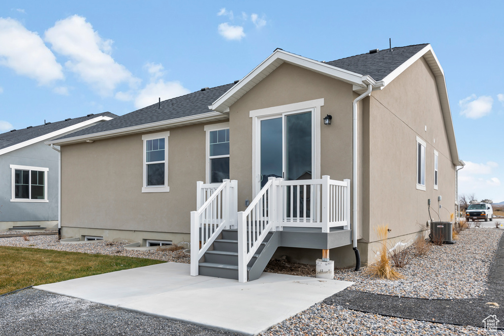 Back of property with a patio and stucco siding