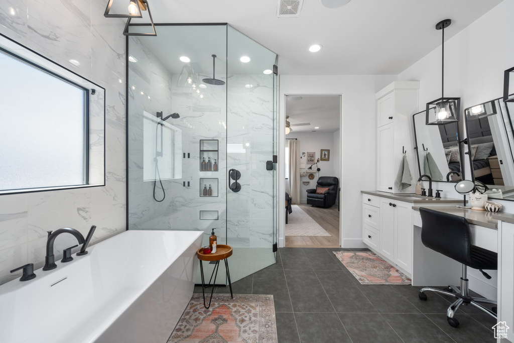 Ensuite bathroom featuring visible vents, vanity, a freestanding tub, connected bathroom, and a marble finish shower