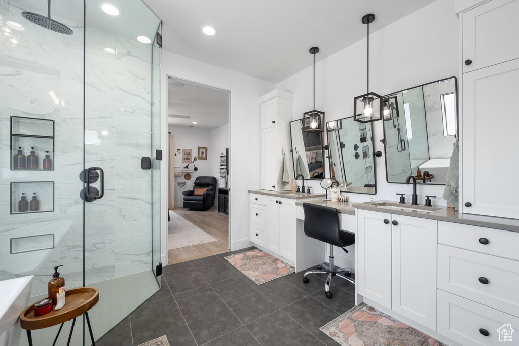 Bathroom with recessed lighting, a marble finish shower, tile patterned flooring, and vanity