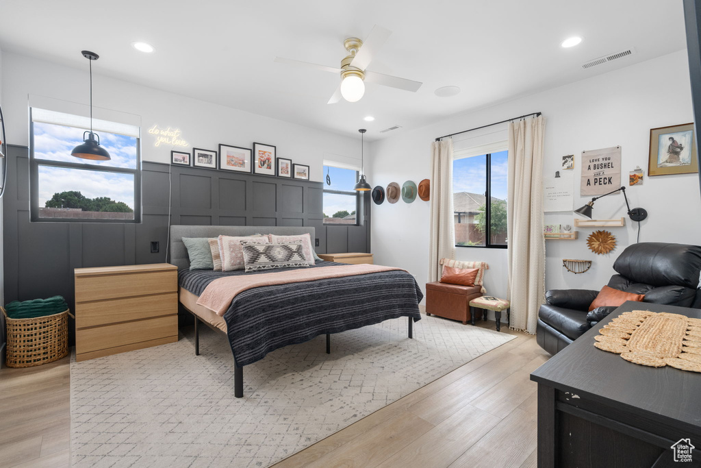 Bedroom with light wood-style floors, recessed lighting, and visible vents