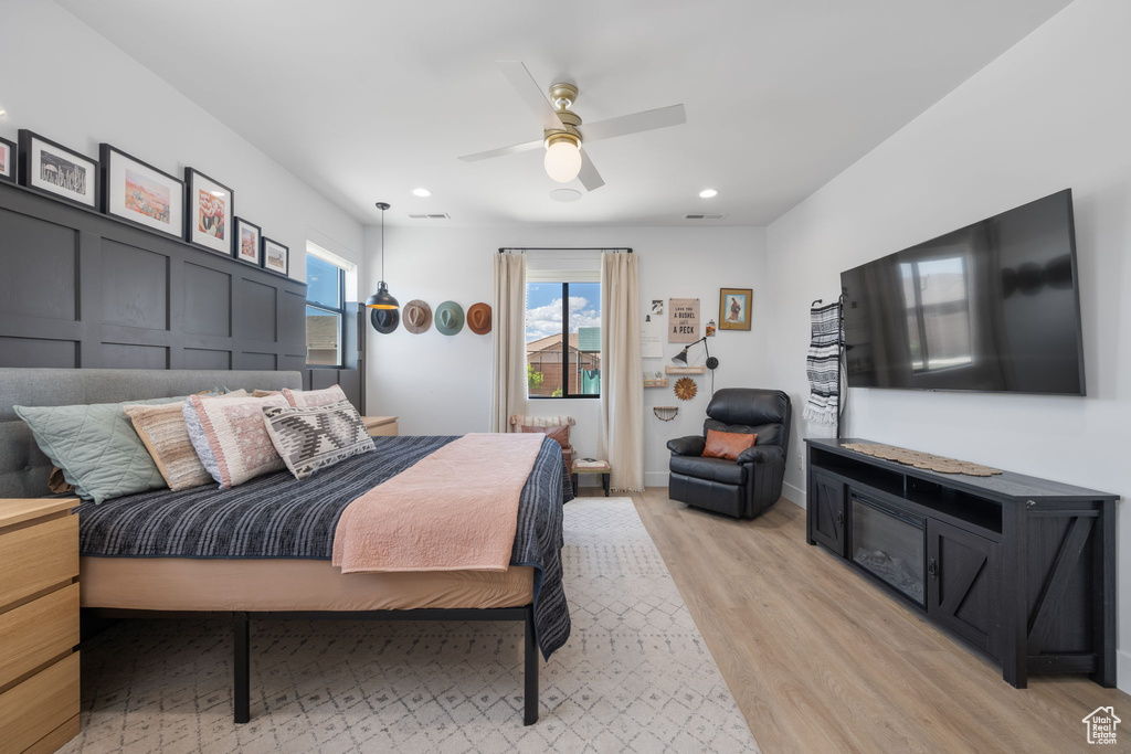 Bedroom with recessed lighting, a ceiling fan, and light wood-style flooring