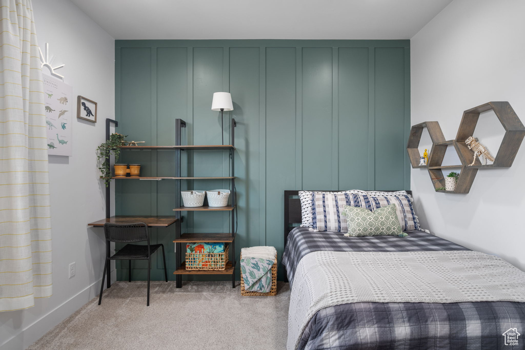 Bedroom with baseboards and carpet flooring