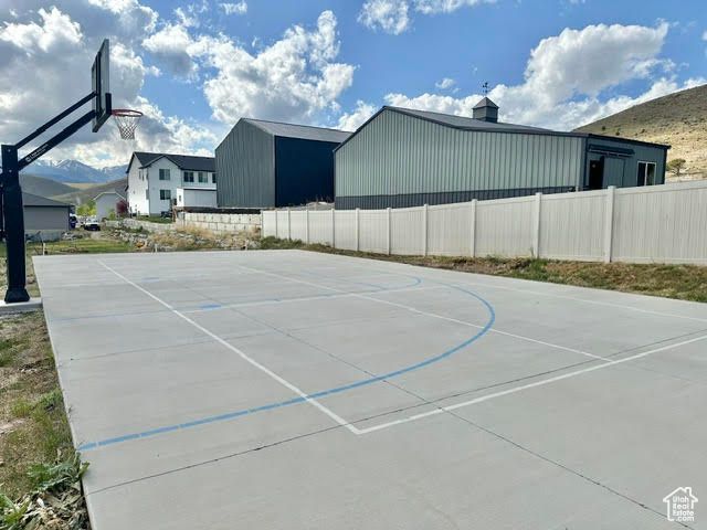 View of basketball court with fence and community basketball court