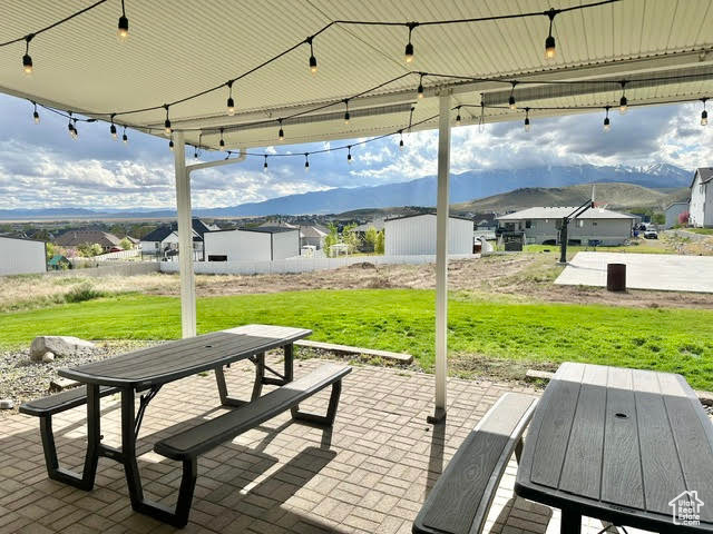View of patio with a residential view and outdoor dining area