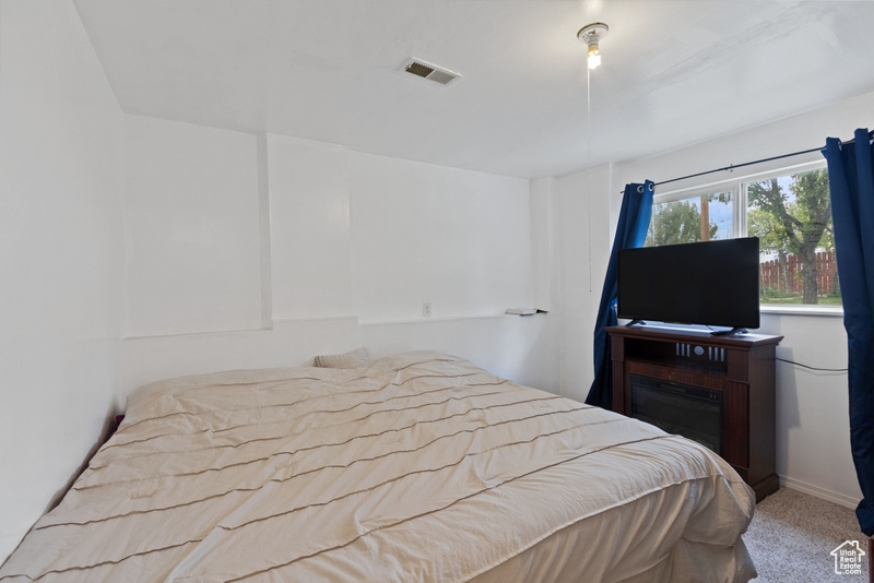 Bedroom with carpet flooring and visible vents