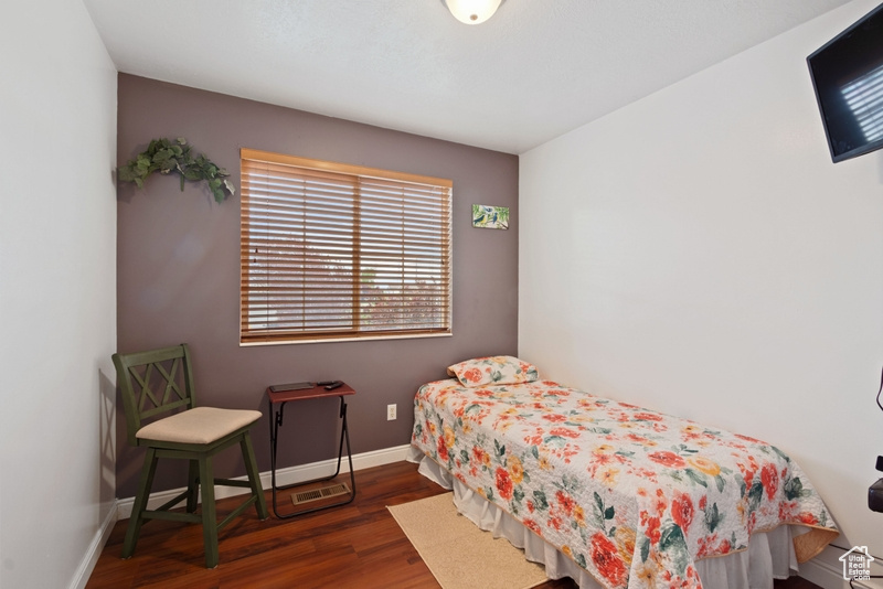 Bedroom with baseboards and wood finished floors