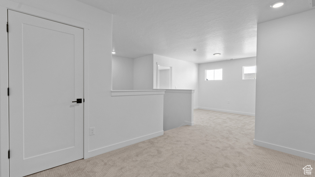 Below grade area with recessed lighting, baseboards, and carpet