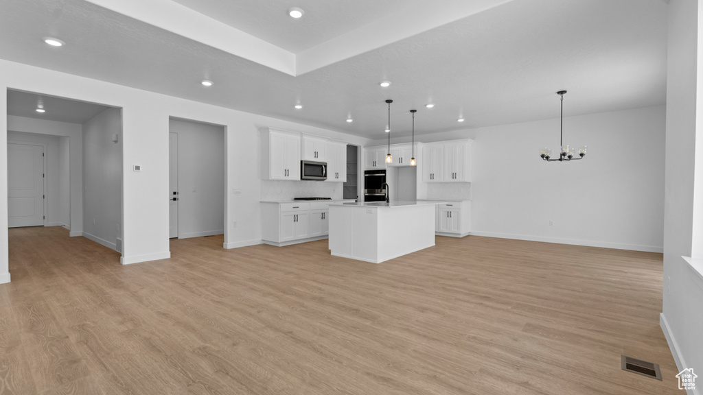 Kitchen featuring visible vents, appliances with stainless steel finishes, baseboards, open floor plan, and recessed lighting