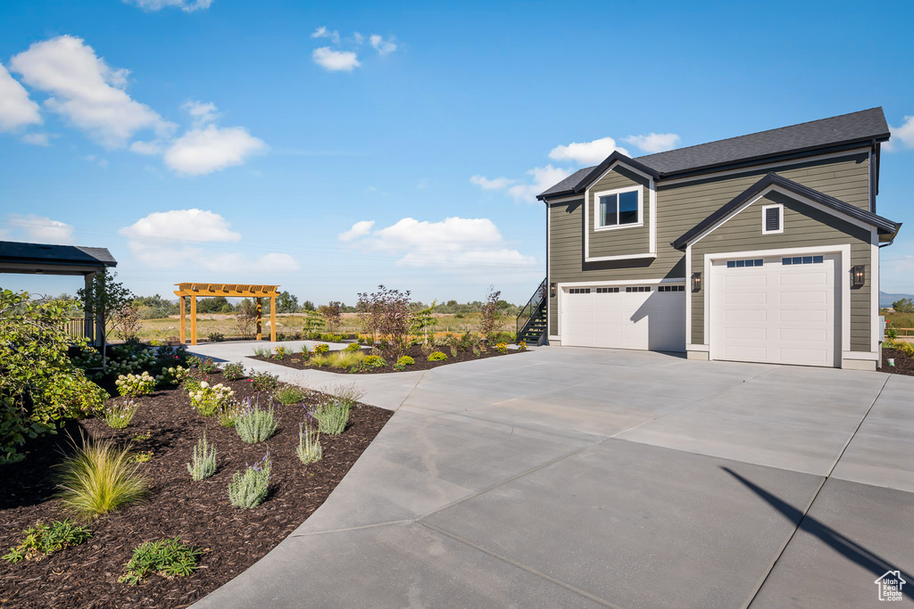 View of front of property featuring an attached garage and driveway