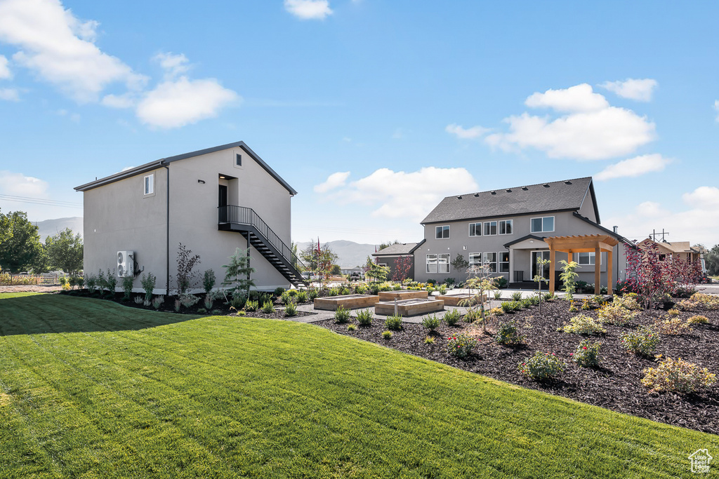 View of yard featuring a pergola, a vegetable garden, and stairway