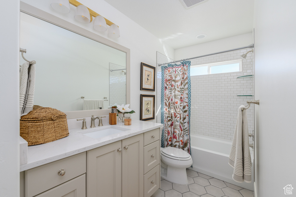 Full bathroom with visible vents, shower / bath combination with curtain, vanity, tile patterned floors, and toilet